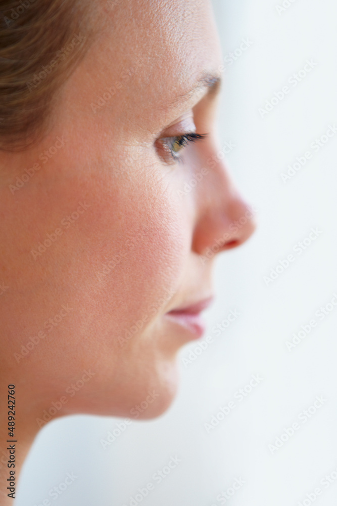 Uncertain of her future. Pensive mature woman looking away - profile view. Uncertain of her future. Pensive mature woman looking away - profile view.