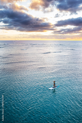 Obraz na plátne Ala Moana Beach Park in Honolulu, Hawaii at sunset, with paddle boarders and swi