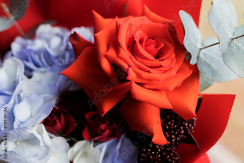 A red rose surrounded by other flowers in a bouquet. Wedding bouquet