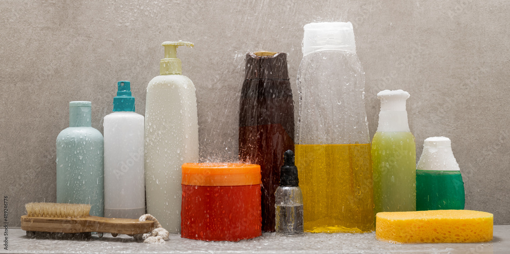 Personal hygiene products in the shower splashed by shower water on gray ceramic Personal hygiene products in the shower splashed by shower water on gray ceramic