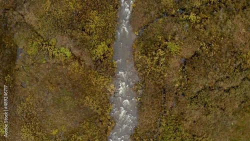 Alaska wild river during autumn time with a drone into the wild in eastern alaska with nordic looking tundra ESTABLISHING SHOT photo