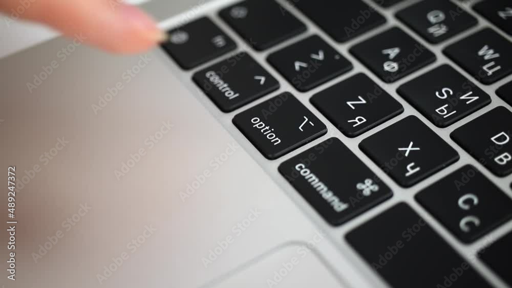 Hand pressing option key on modern laptop keyboard close-up slow motion Hand pressing option key on modern laptop keyboard close-up slow motion