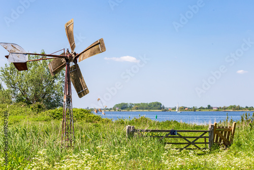 Landscape with littel water mill of island and nature reserve Tiengemeten Hoeksche Waard n South Holland in The neteherlands photo