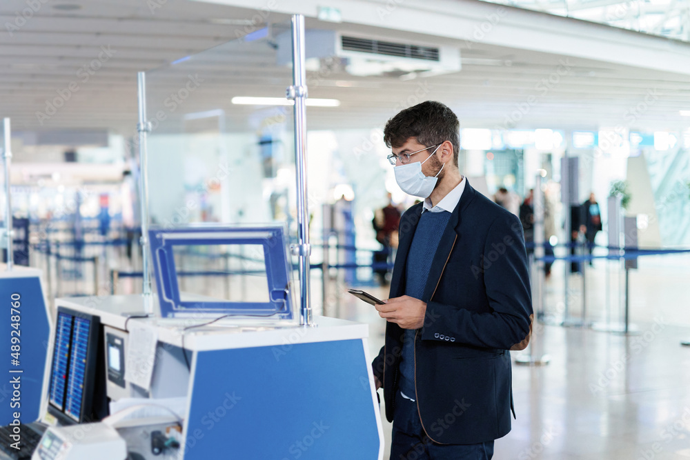 business man with documents near the check-in desk at the airport. business man with documents near the check-in desk at the airport.