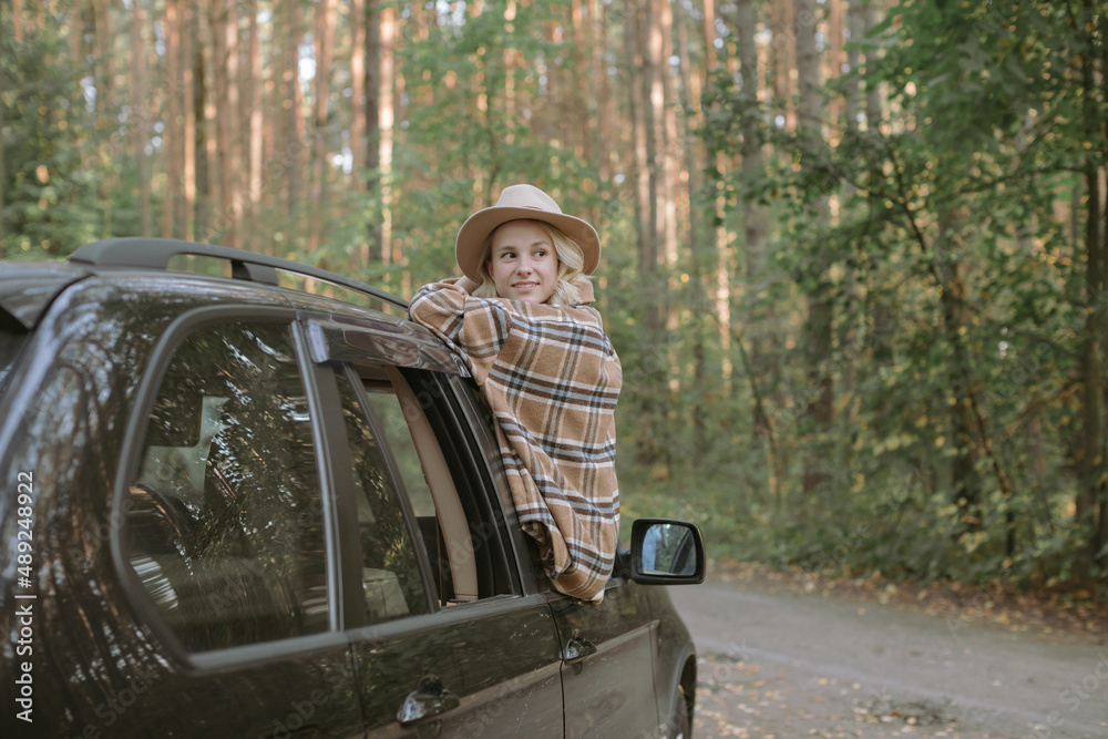Young woman going out the window of a car. Road trip. Young woman going out the window of a car. Road trip.