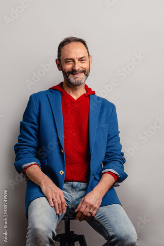 Portrait of sexy mature grey bearded man. Stylish bearded senior bearded man looking at camera isolated on grey background.