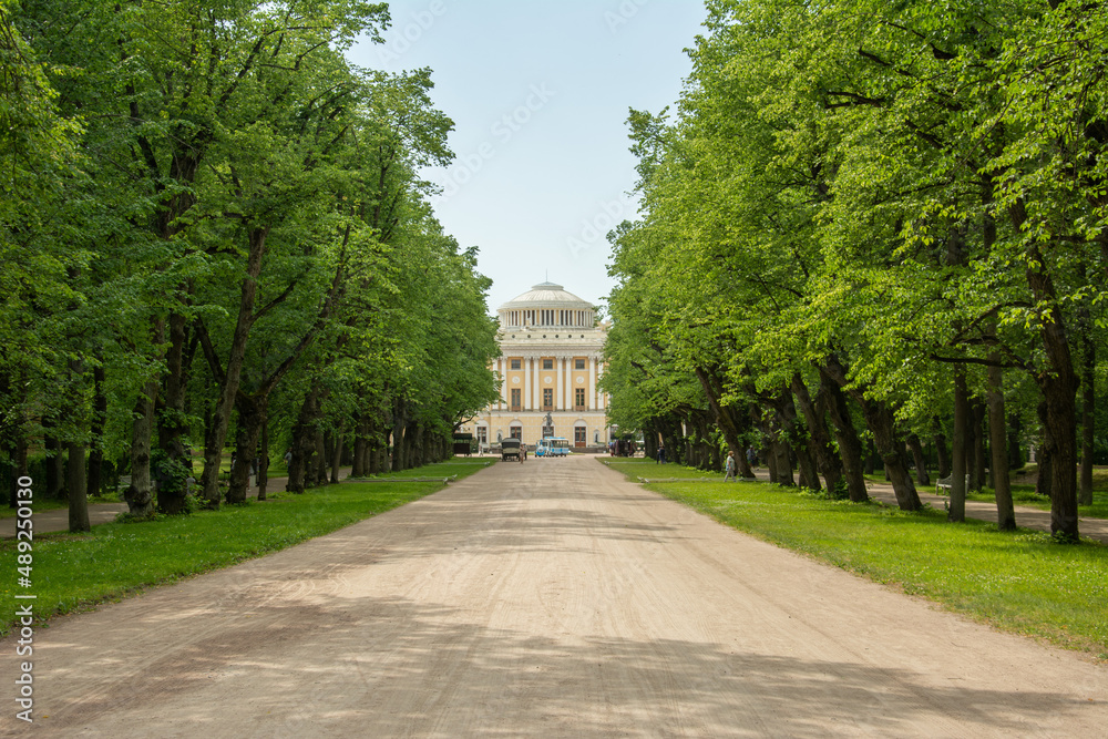 The view of the 18th century Pavlovsk Imperial Palace built by the order of Catherine the Great from the green alley in Pavlovsk, Russia