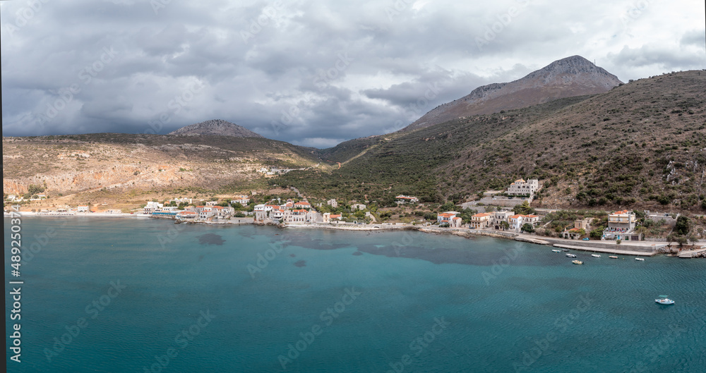 Greece, Mani New Oitylo seaside fishing village under cloudy sky, aerial view. Peloponnese. Laconia