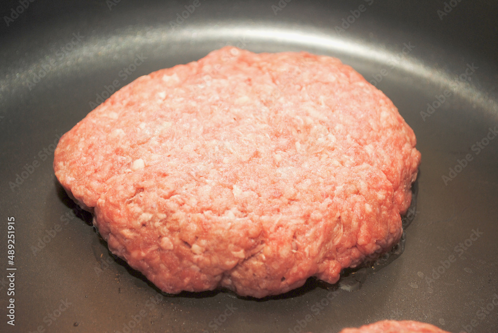Frying Burgers in a Black Pan Frying Burgers in a Black Pan