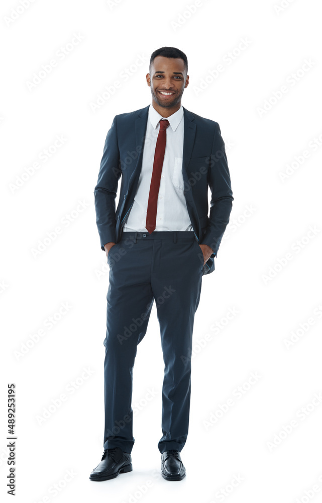 Positivity brings him success. A smiling businessman with his hands in his pockets while isolated on white.