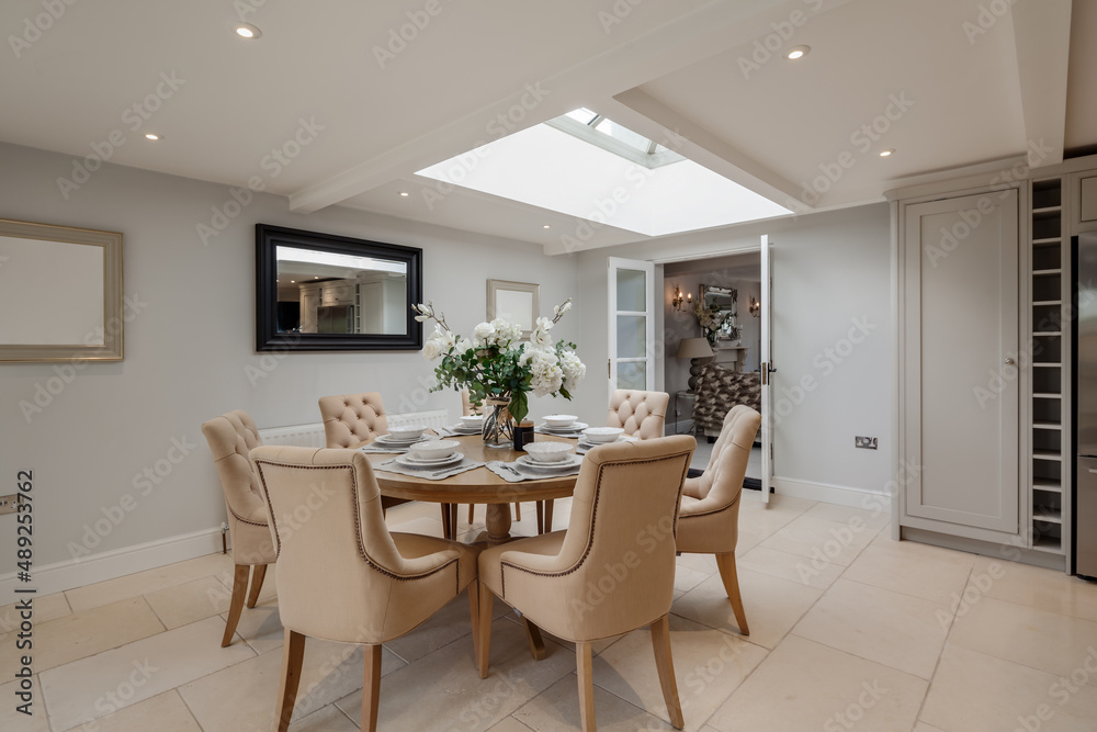 Dining table in room decorated in shades of white Dining table in room decorated in shades of white