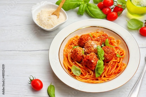Italian Traditional Dish"Spaghetti con le polpette",spaghetti and meatballs on plate with white wood table background.Top view.Copy space