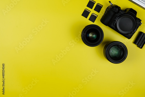 Layout: camera, memory cards, lenses on a yellow background
