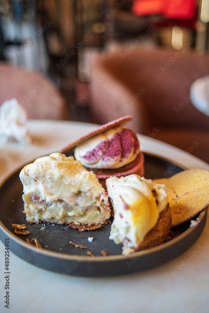Colourful danish fastelavnsbolle with jam, whipped cream and almond paste in laminated pastry dough with powdered sugar on top served in Copenhagen, Denmark in a cafe bakery Andersen Bakery Colourful danish fastelavnsbolle with jam, whipped cream and almond paste in laminated pastry dough with powdered sugar on top served in Copenhagen, Denmark in a cafe bakery Andersen Bakery