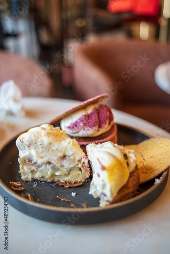 Colourful danish fastelavnsbolle with jam, whipped cream and almond paste in laminated pastry dough with powdered sugar on top served in Copenhagen, Denmark in a cafe bakery Andersen Bakery