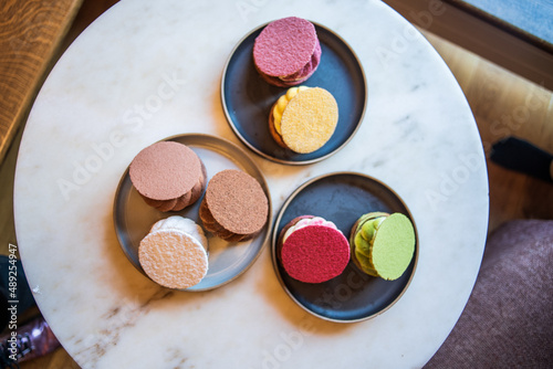 Colourful danish fastelavnsbolle with jam, whipped cream and almond paste in laminated pastry dough with powdered sugar on top served in Copenhagen, Denmark in a cafe bakery Andersen Bakery