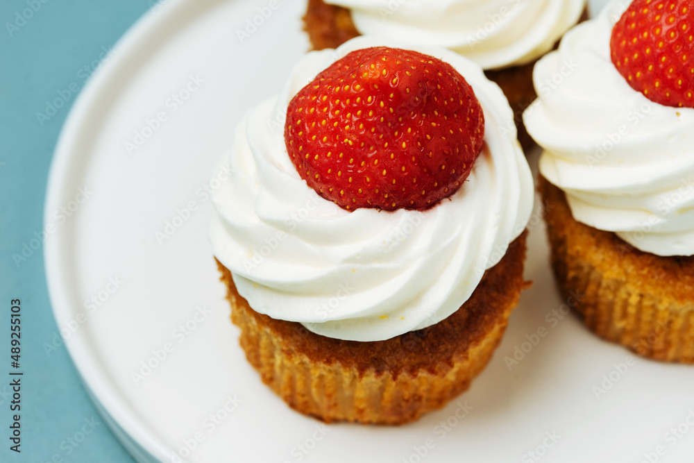 Delicious cupcakes topped with raspberries Delicious cupcakes topped with raspberries