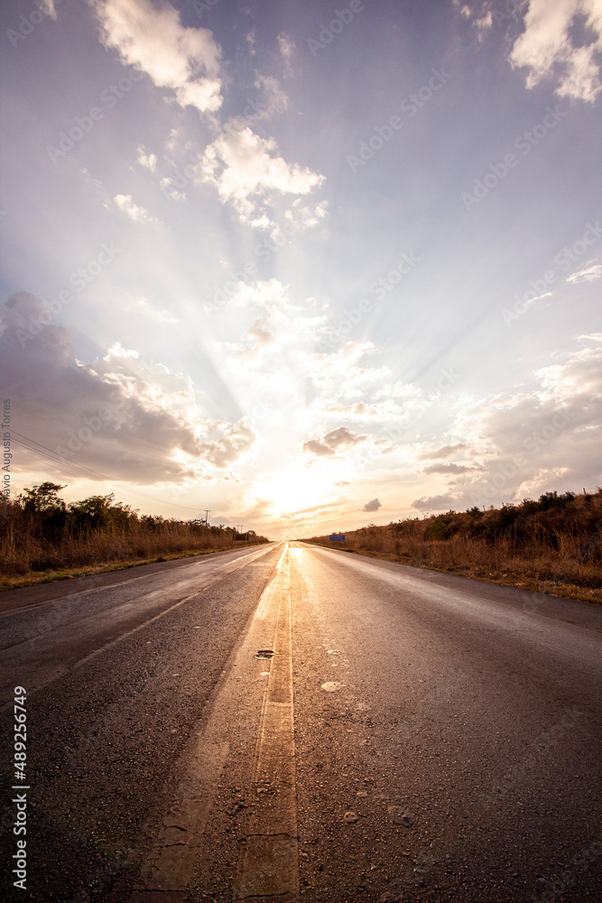 Road and car in sunset.