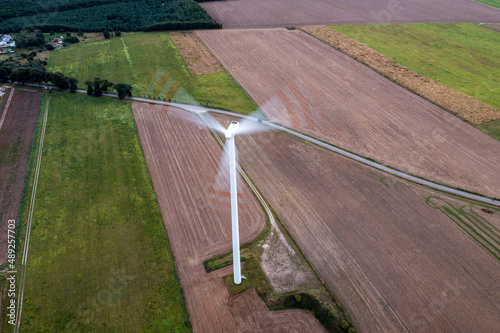 Going green with a wind power from a modern eco windmill turbine.