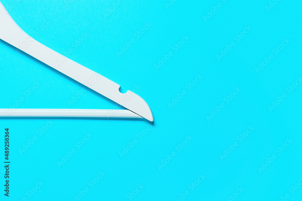 Clothes hanger on blue background Clothes hanger on blue background