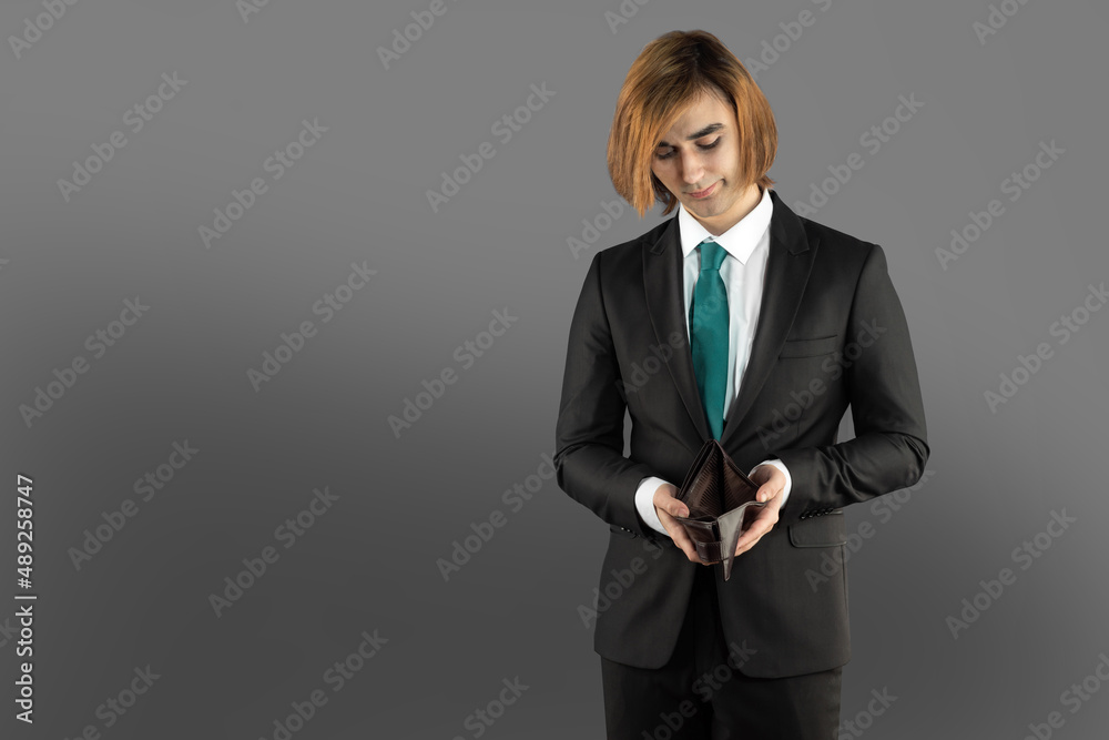 Prep Student young man with empty wallet. Businessman without money. The concept of loss, lost savings, failed startup Prep Student young man with empty wallet. Businessman without money. The concept of loss, lost savings, failed startup