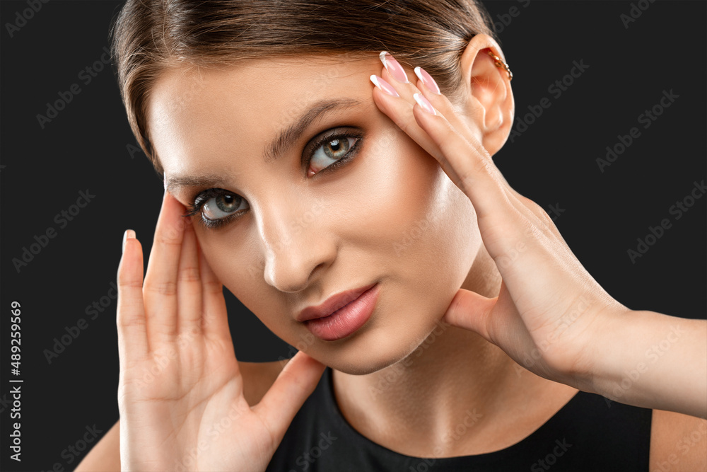 Fototapeta premium Portrait of attractive girl with healthy clean skin and beautiful make-up. Aesthetic cosmetology and makeup concept.