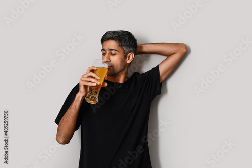 Handsome man drinking beer ...