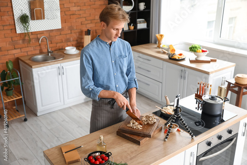 Young man cutting mushrooms...