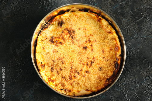 Wallpaper Mural Whole golden homemade pie in a round shape on a black background. top view Torontodigital.ca