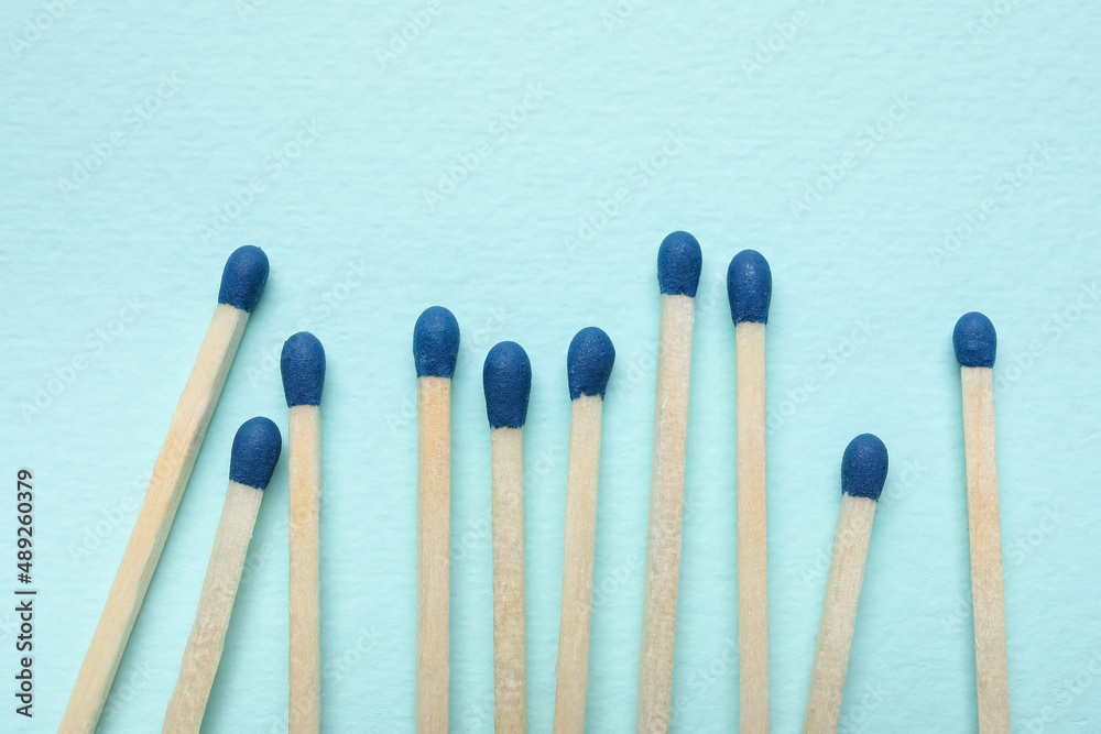 New matchsticks on blue background, closeup New matchsticks on blue background, closeup
