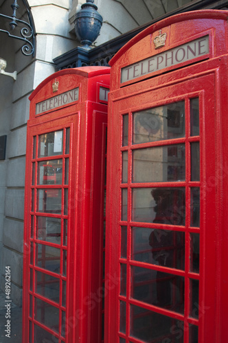 Two red phone booths in London.