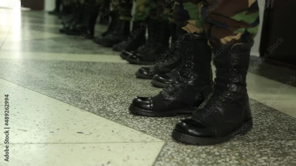 Russian army soldiers line up on alert, black military boots and dark green military uniform. anxiety for war