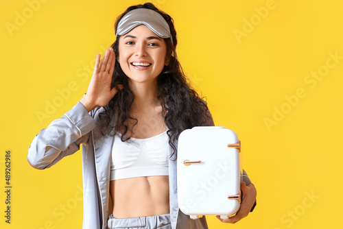 Young happy woman in pajama...