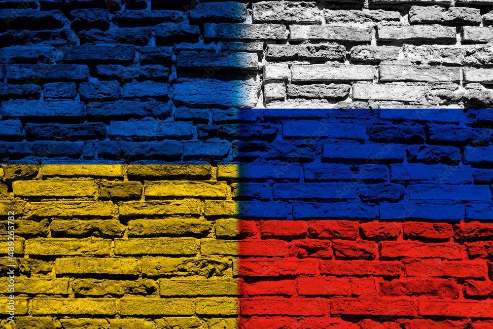 Background with the flag of Ukraine and Russia on a brick wall Background with the flag of Ukraine and Russia on a brick wall