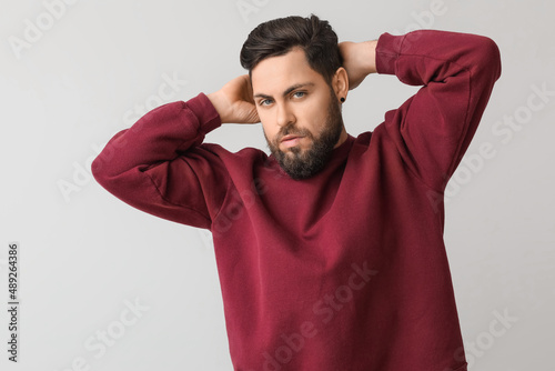 Stylish bearded man on ligh...