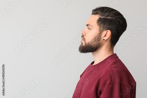 Stylish bearded man on ligh...