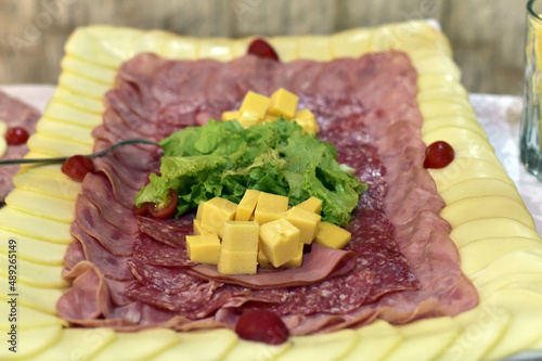 delicious sliced ​​cheese with salami ham and salad, party buffet