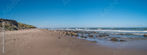 Panoramic view over seashore, beach and lighthouse in Hirtshals, Denmark, summer, at blue sky and sunny day.