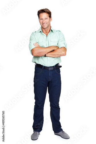Casual and comfortable. An isolated portrait of a happy man standing with his arms crossed.