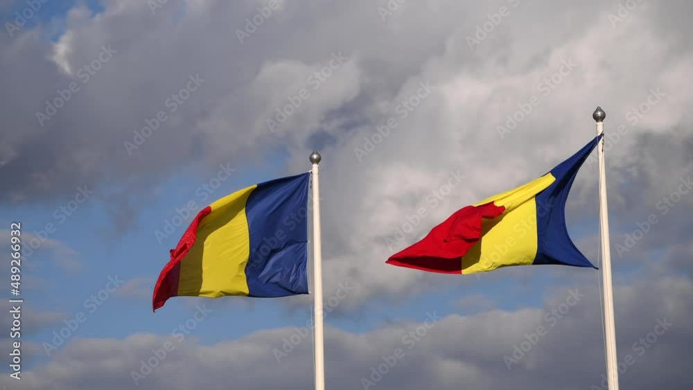 4k video with the flag of Romania winding against a spectacular cloudy blue sky 4k video with the flag of Romania winding against a spectacular cloudy blue sky