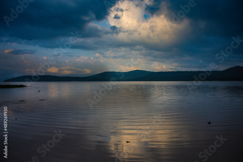 Blue sunrise on a water mirror cloudy