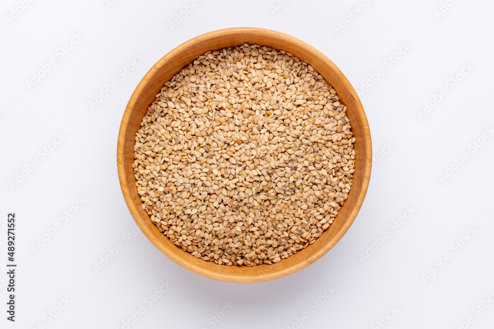Bio natural sesame seeds on wooden bowl. Bio natural sesame seeds on wooden bowl.