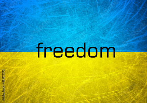 A grunge flag of Ukraine. Blue and yellow horizontal lines. Freedom word