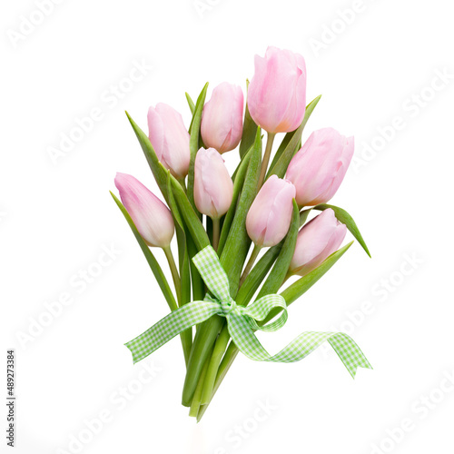 Fresh pink tulip flowers bouquet on shelf in front of wooden wall. #489273384