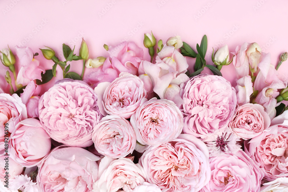 Fototapeta premium Delicate blooming festive roses and light pink flowers background, blossoming rose flower soft pastel frame, bouquet floral card, selective focus