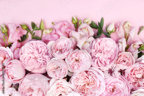 Fototapeta Naklejka Na Ścianę i Meble -  Delicate blooming festive roses and light pink flowers background, blossoming rose flower soft pastel frame, bouquet floral card, selective focus