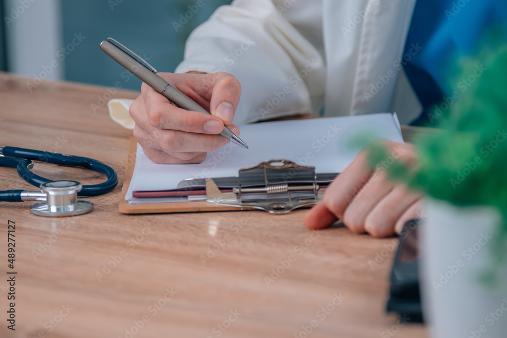 Fototapeta premium doctor hand writing in surgery or hospital