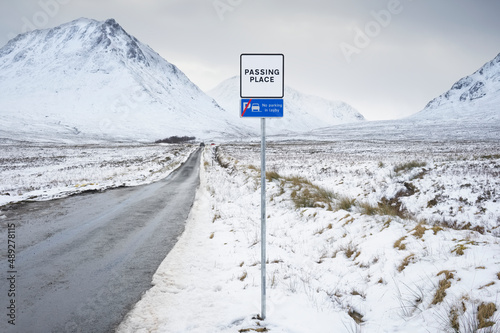 Картината върху платно Buachaille Etive Mor mountain and empty road covered in snow during winter