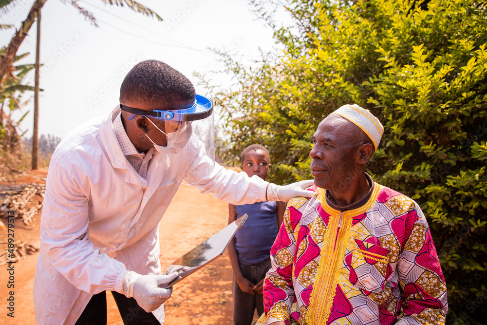 African doctor visits an elderly patient and they converse during the medical examination. Health care in africa concept - obrazy, fototapety, plakaty 