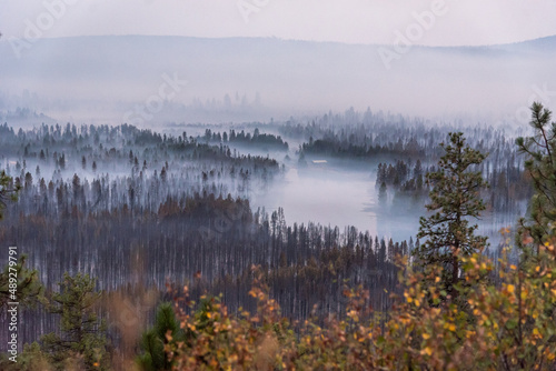 Smoke settles in a valley following a destructive wildfire